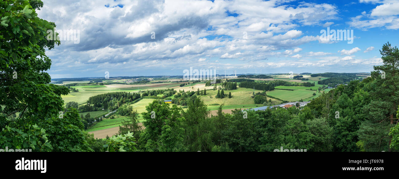 Panorama from a high altitude to a valley with fields and windmills. Hof, Bavaria, Germany. Stock Photo