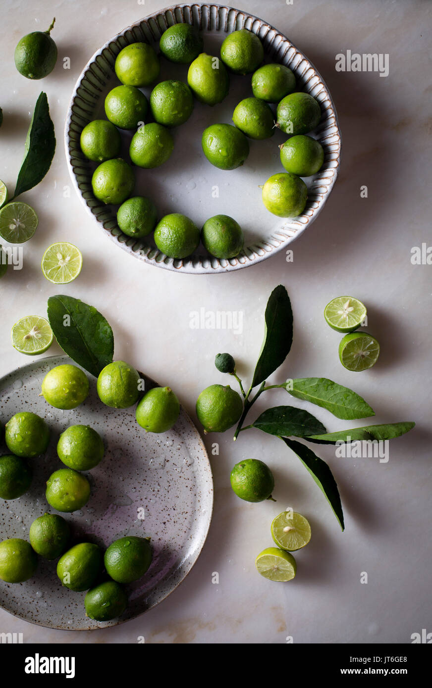 Key lime with leaves in a ceramic bowl Stock Photo - Alamy