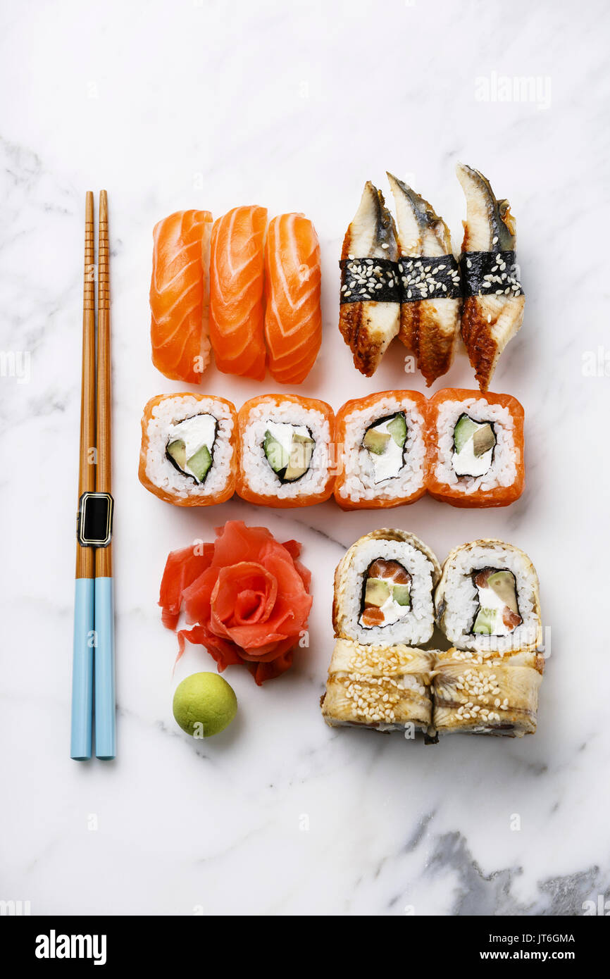 Sushi Set nigiri and sushi rolls on wooden serving board with soy sauce,  chopsticks, ceramic teapot over white marble background. Flat lay, space.  Jap Stock Photo - Alamy