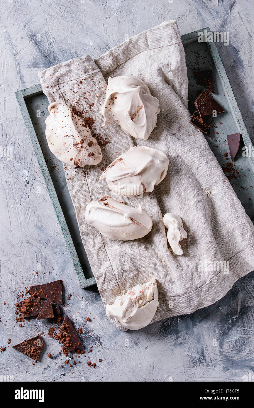 Baking homemade french dessert meringue with chocolate served with dark chopping chocolate and