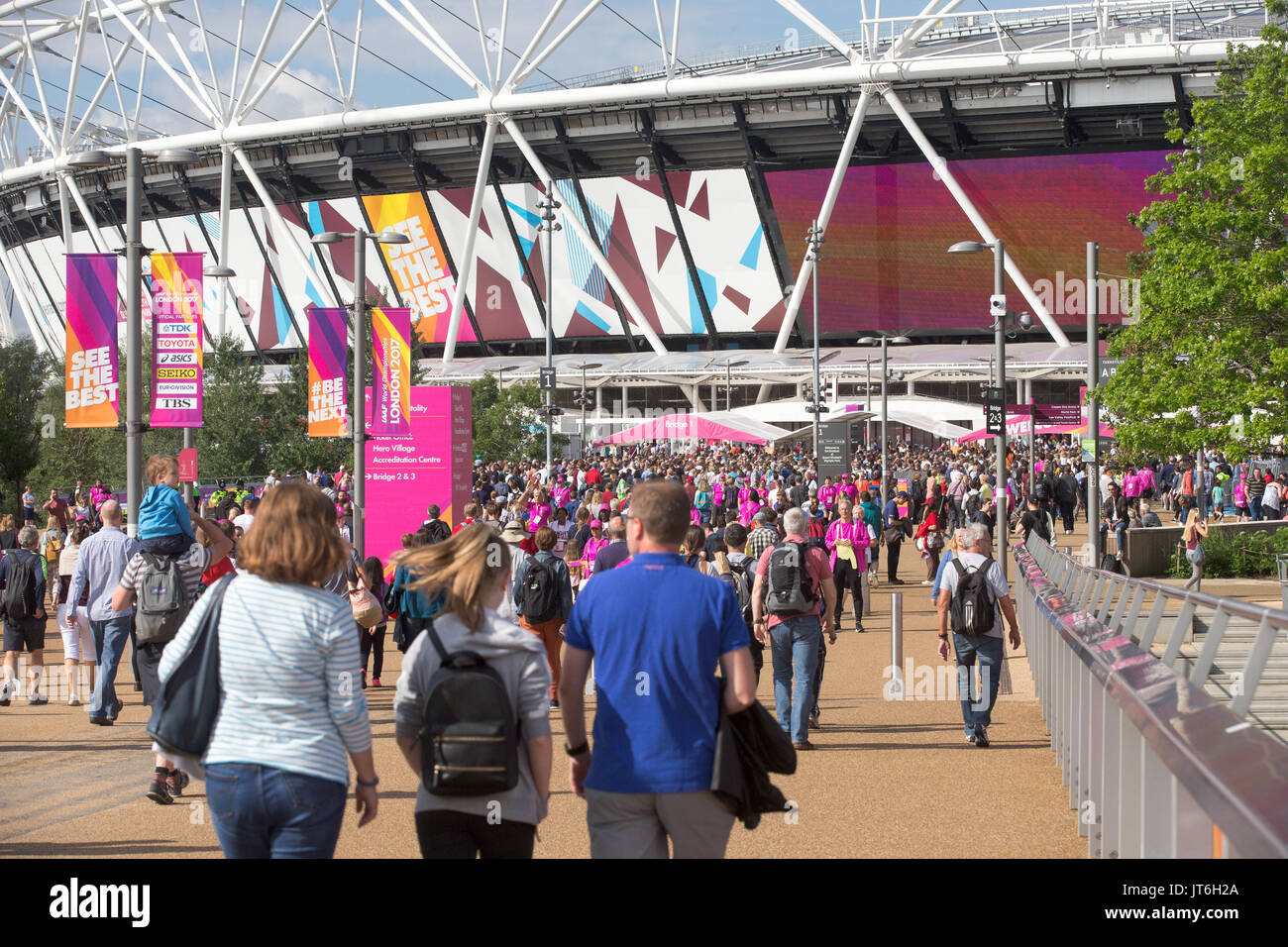 SPORTS FANS ARRIVING AT THE LONDON STADIUM FOR THE IAAF World Athletics  Championships AND BEING HELPED BY VOLUNTEERS Stock Photo - Alamy