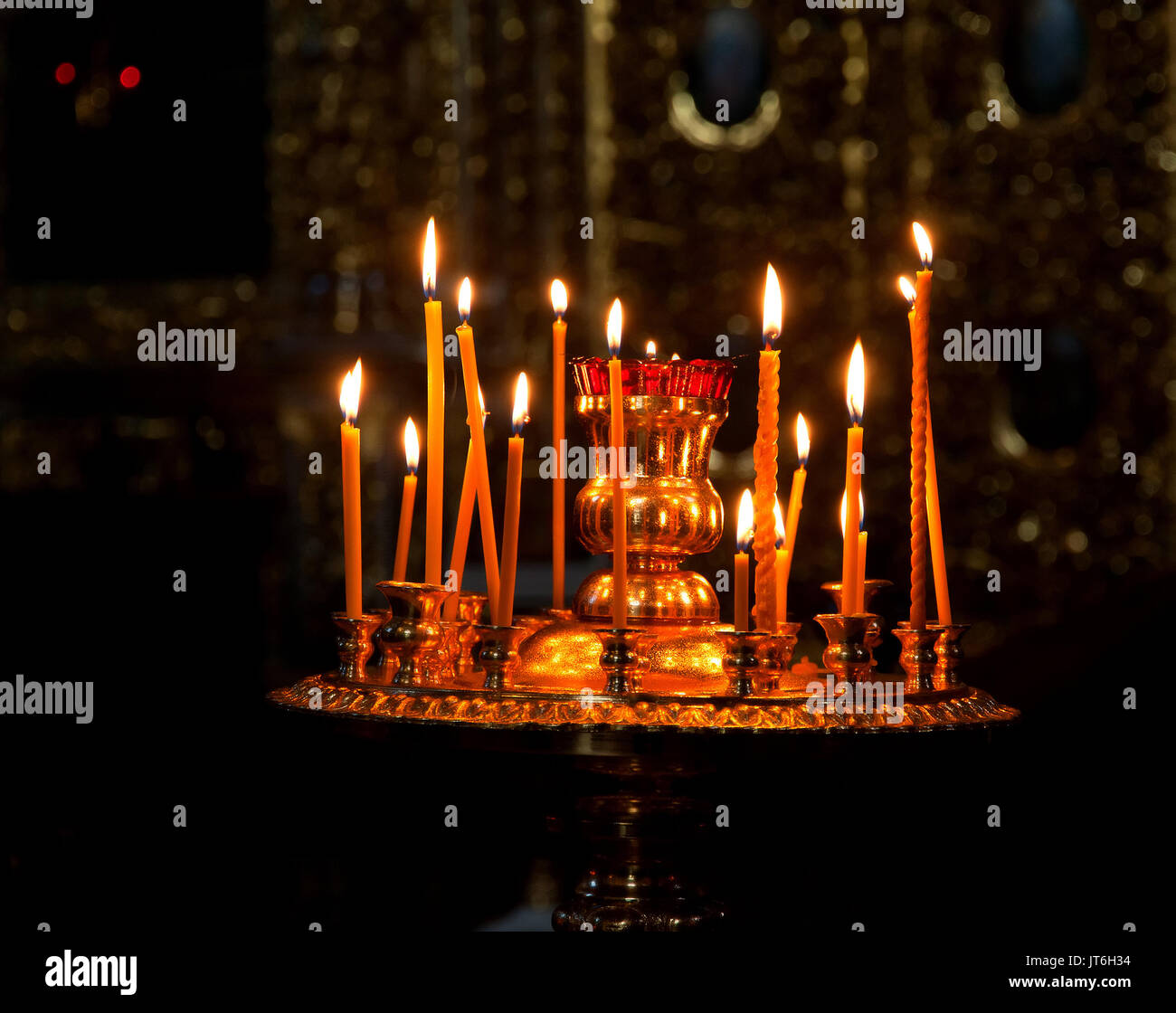 Religion and Christianity symbols candles in front of icons in a
