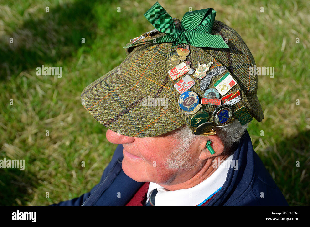 Badges on a deerstalker hat worn by a clay shooter Stock Photo