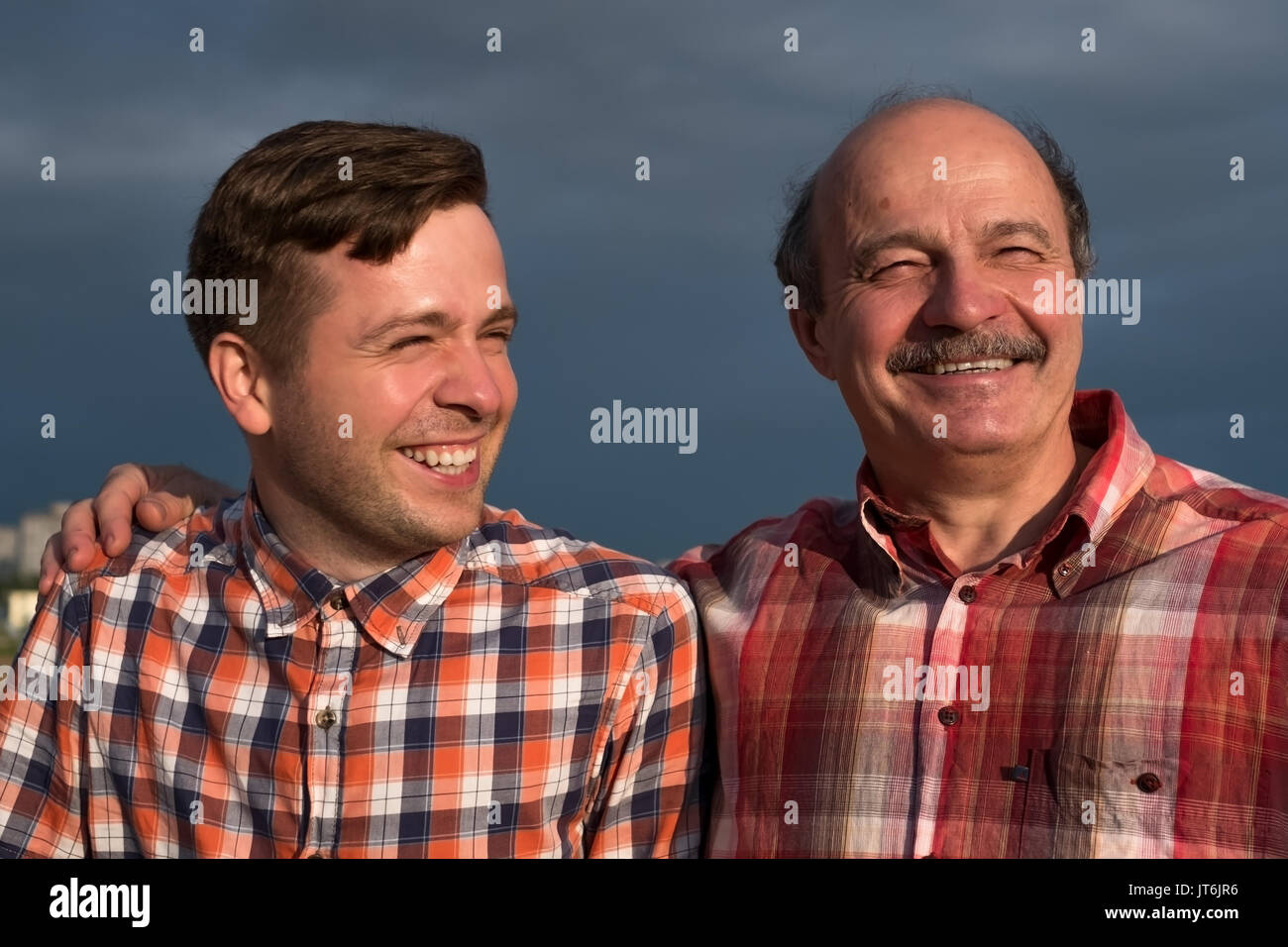 portrait of happy father and son walking outdoors. Stock Photo