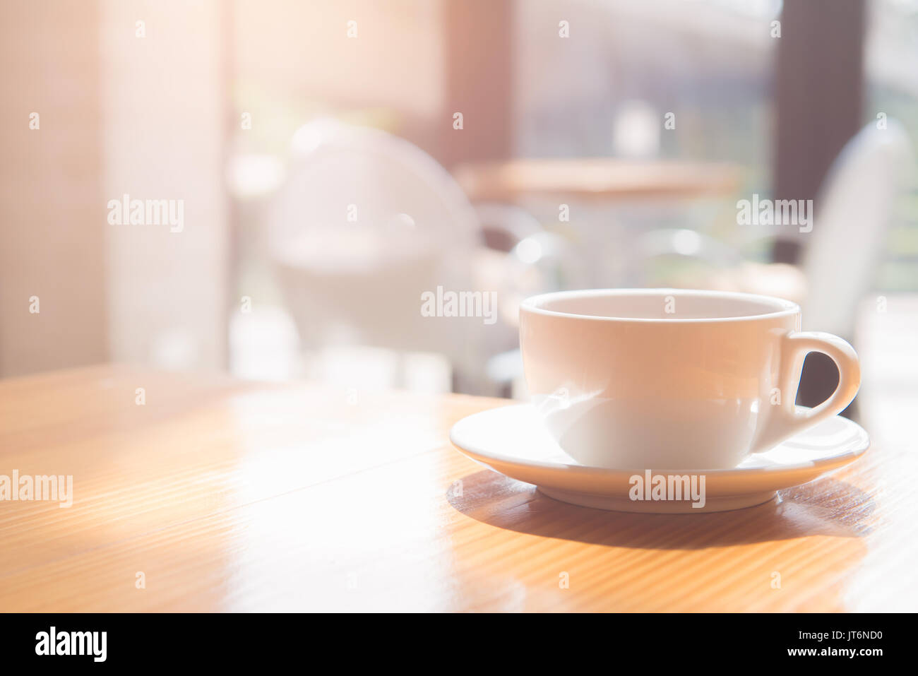 good morning a tea or coffee cup on wooden table in coffee shop. soft focus Stock Photo