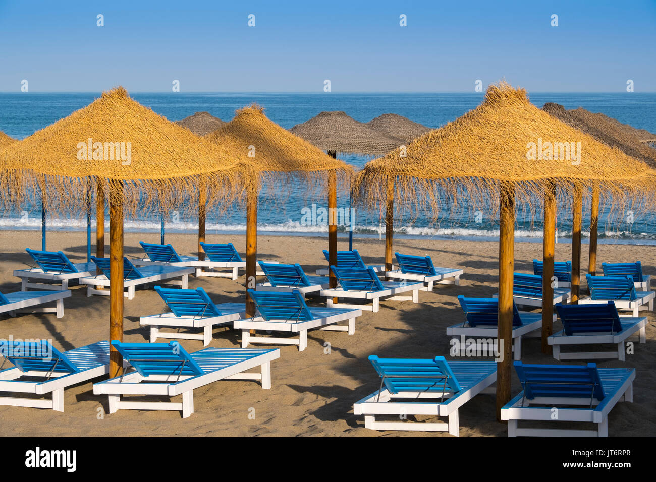 Straw umbrellas & Hammock, beach, La Cala de Mijas. Costa del Sol, Málaga province. Andalusia, Southern Spain Europe Stock Photo