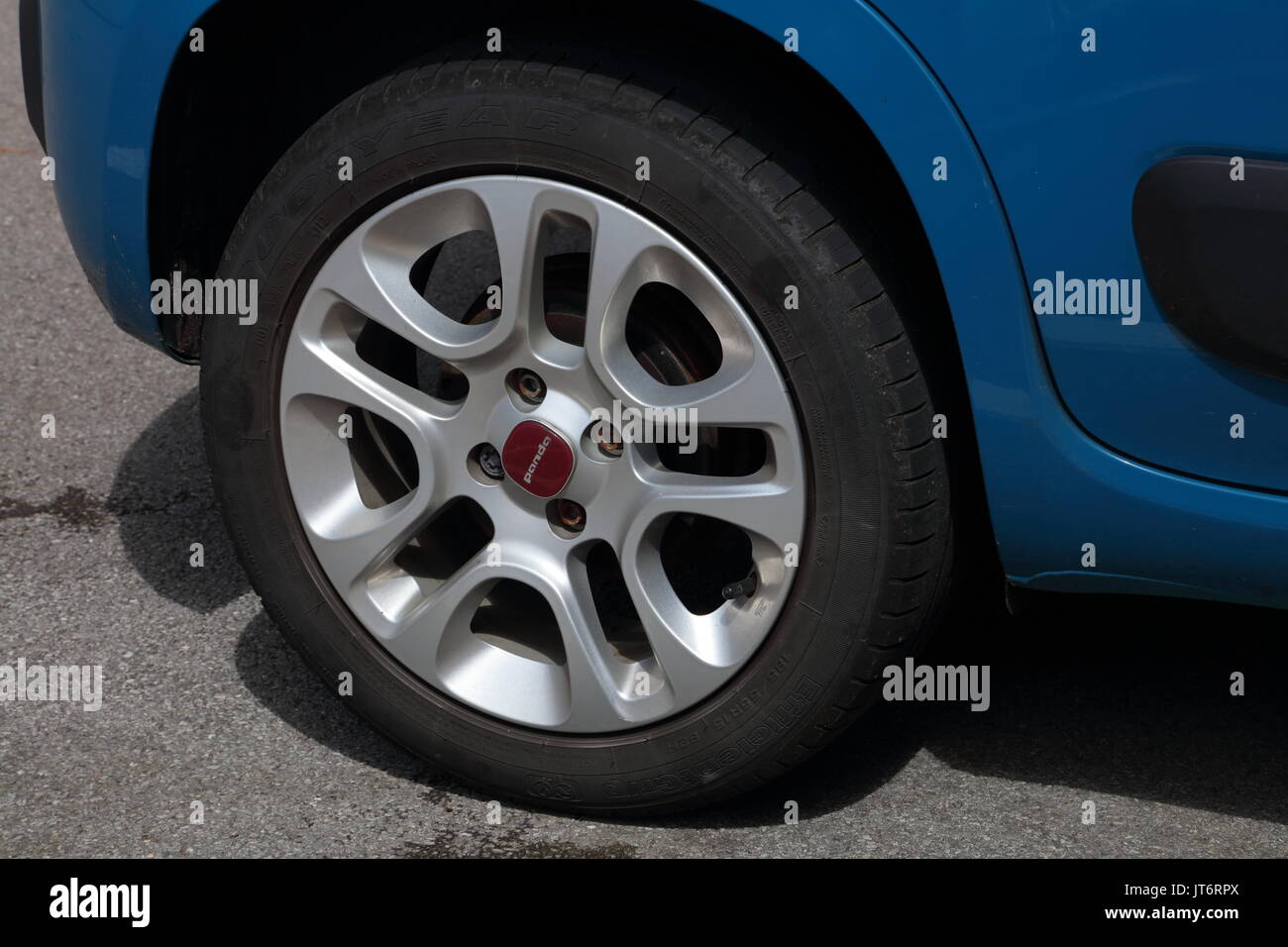An alloy wheel fixed to a static car with one lock nut and three