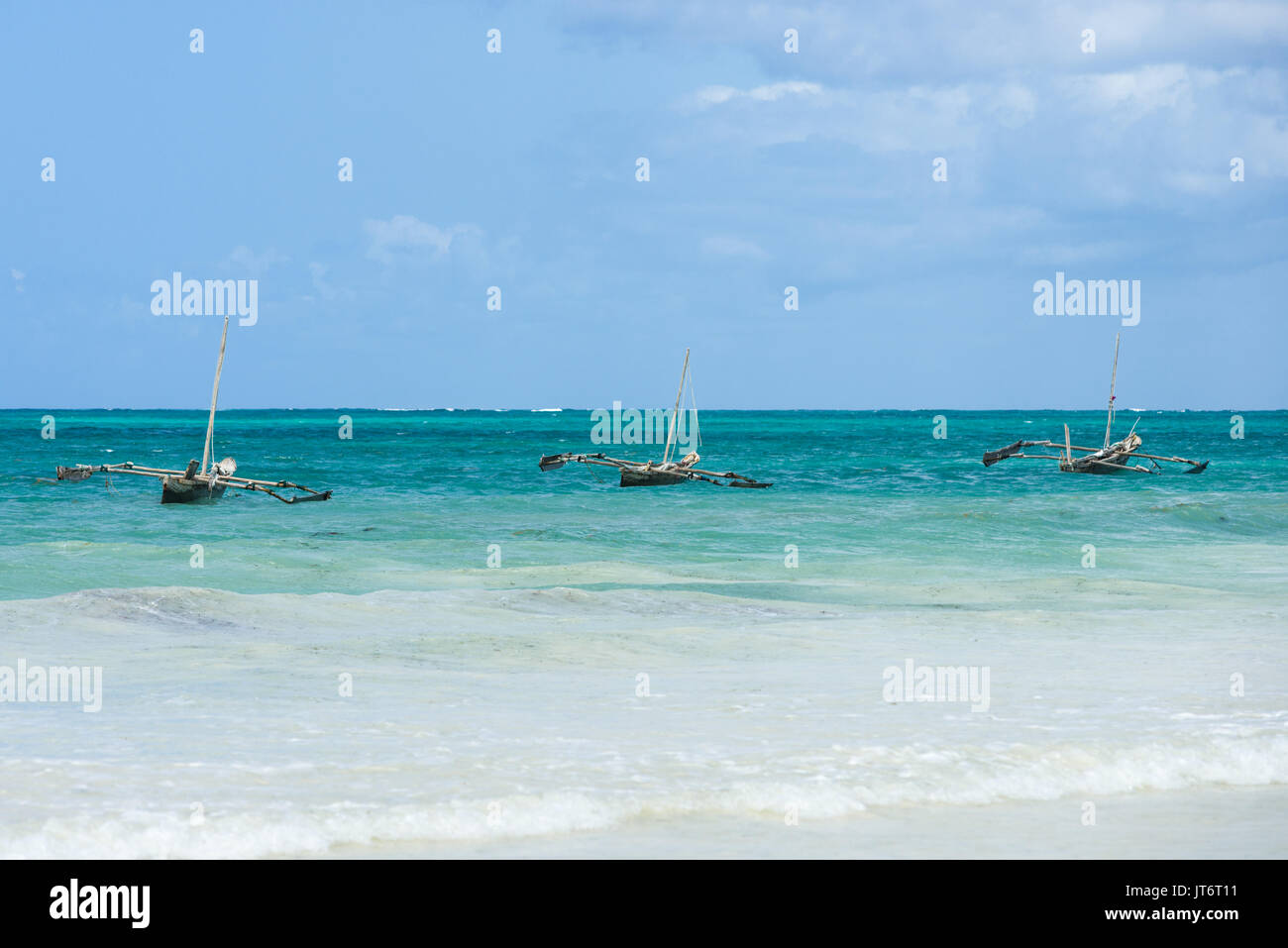 Traditional dhow wooden fishing boats anchored off shore, Diani, Kenya Stock Photo