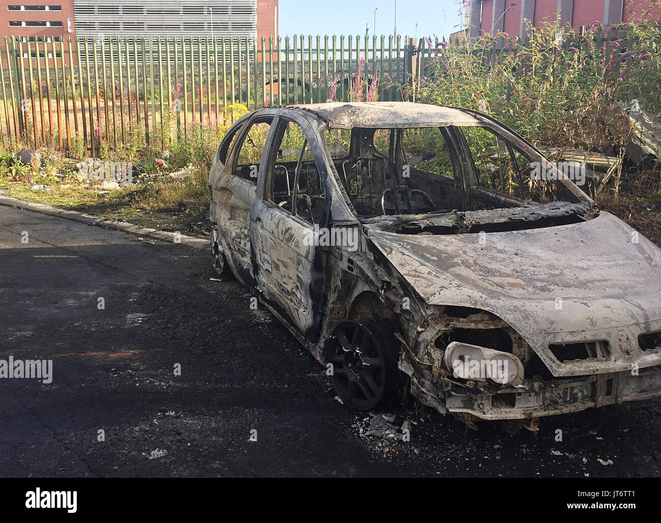 A burned out car in the Markets area of Belfast, where Police have been attacked and cars torched by masked youths apparently angered by the removal of wood from the site of a nationalist bonfire in Belfast. Stock Photo