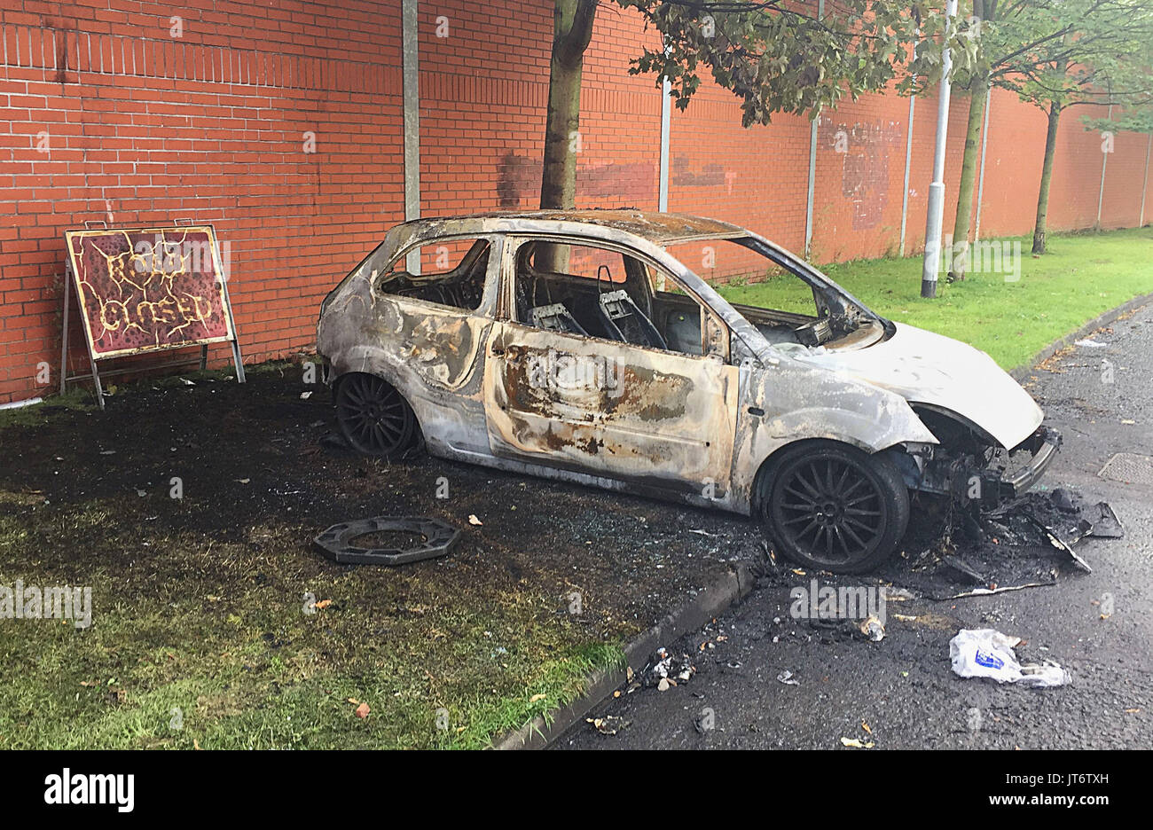 A burned out car in the Markets area of Belfast, where Police have been attacked and cars torched by masked youths apparently angered by the removal of wood from the site of a nationalist bonfire in Belfast. Stock Photo
