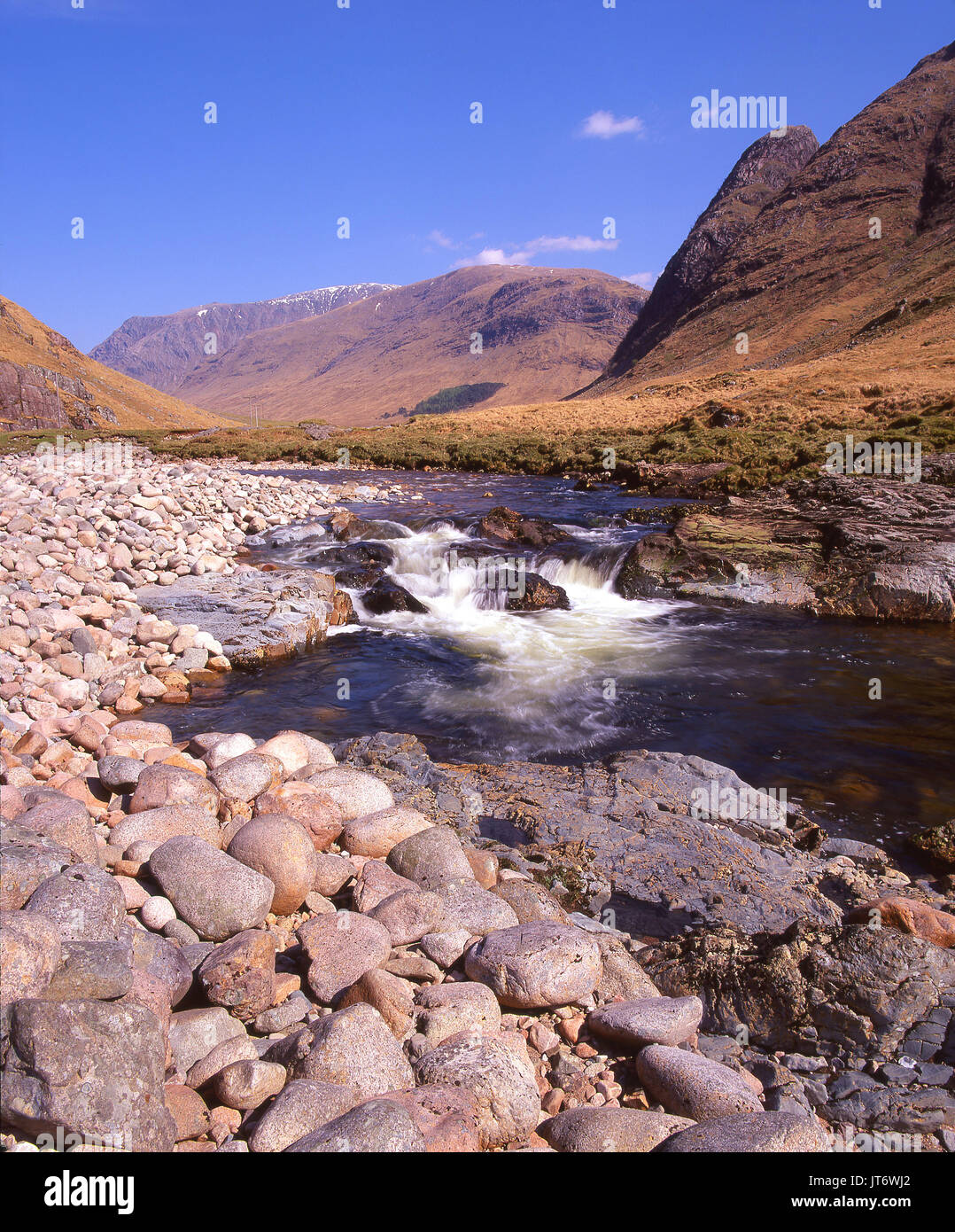 A dramatic scene in picturesque Glen Etive as seen from the fast flowing River Etive, Argyll Stock Photo