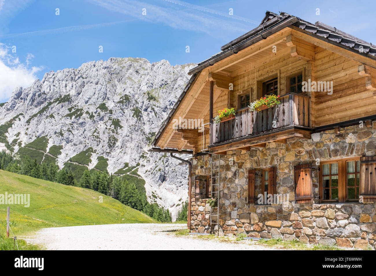 Old stone hut with mountain Gartnerkofel in the background on Nassfeld in Carnic Alps in Austria Stock Photo
