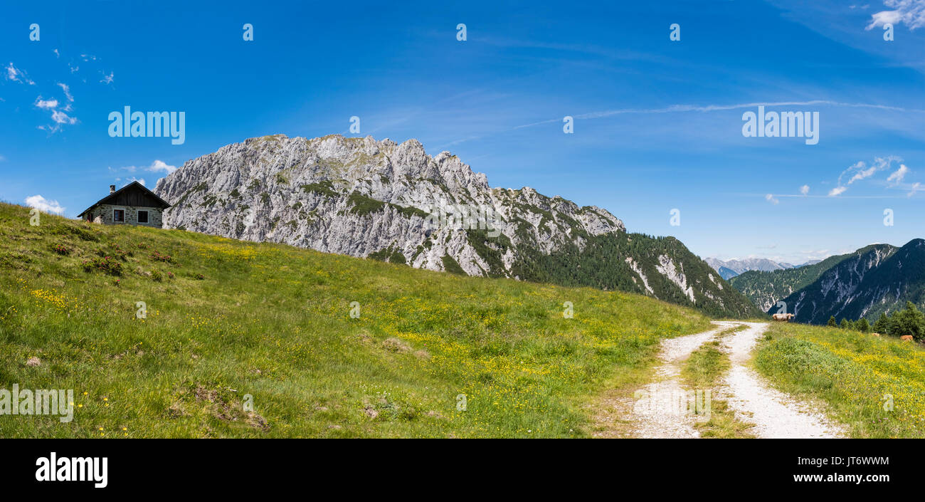 Old stone hut with mountain Gartnerkofel in the background on Nassfeld in Carnic Alps in Austria Stock Photo