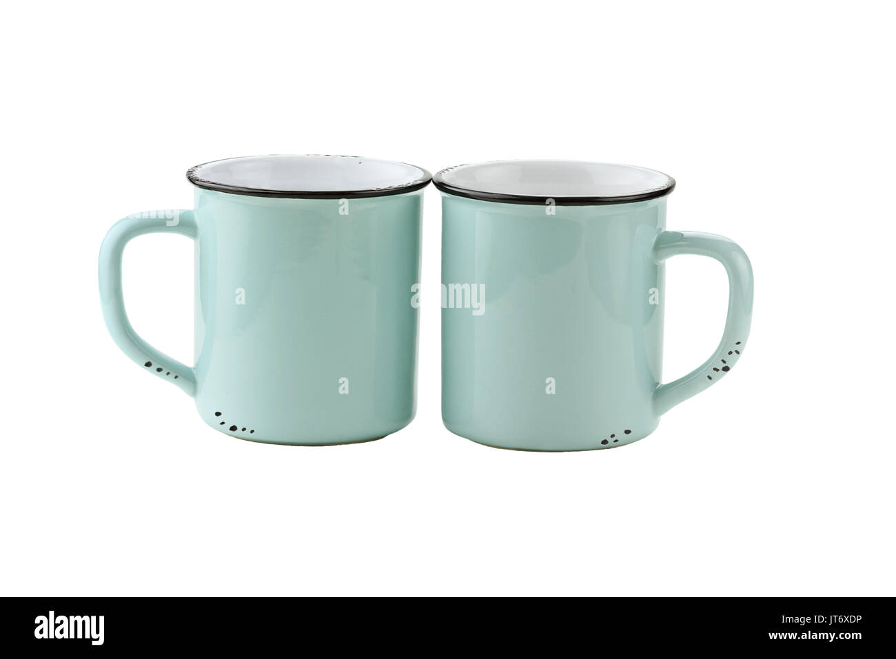 Two teal colored enamel coffee cups or mugs with copy space for logo isolated over a white background with clipping path included. Stock Photo