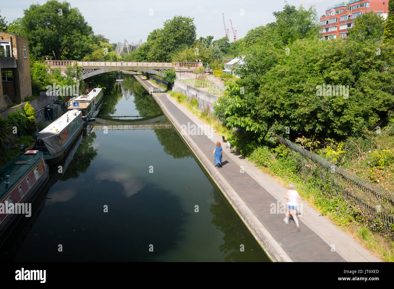 Camden Town, London, UK. Joggers and walkers on the towpath along Camden Canal near London Zoo. Stock Photo