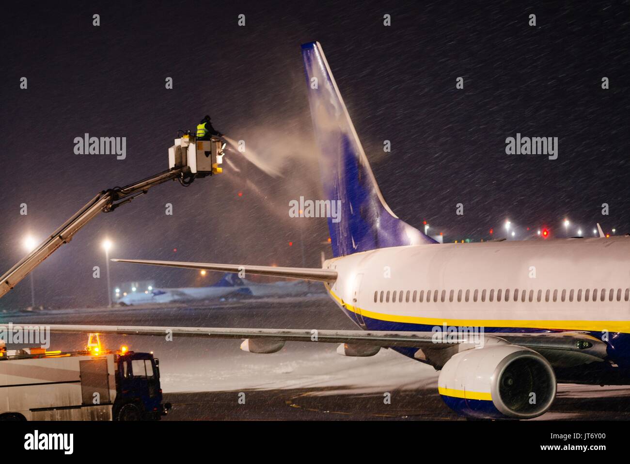 Deicing passenger plane with glycol at night Stock Photo Alamy