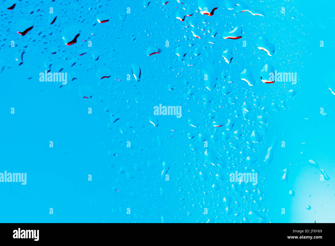 Drops on the glass rain blue background Stock Photo - Alamy