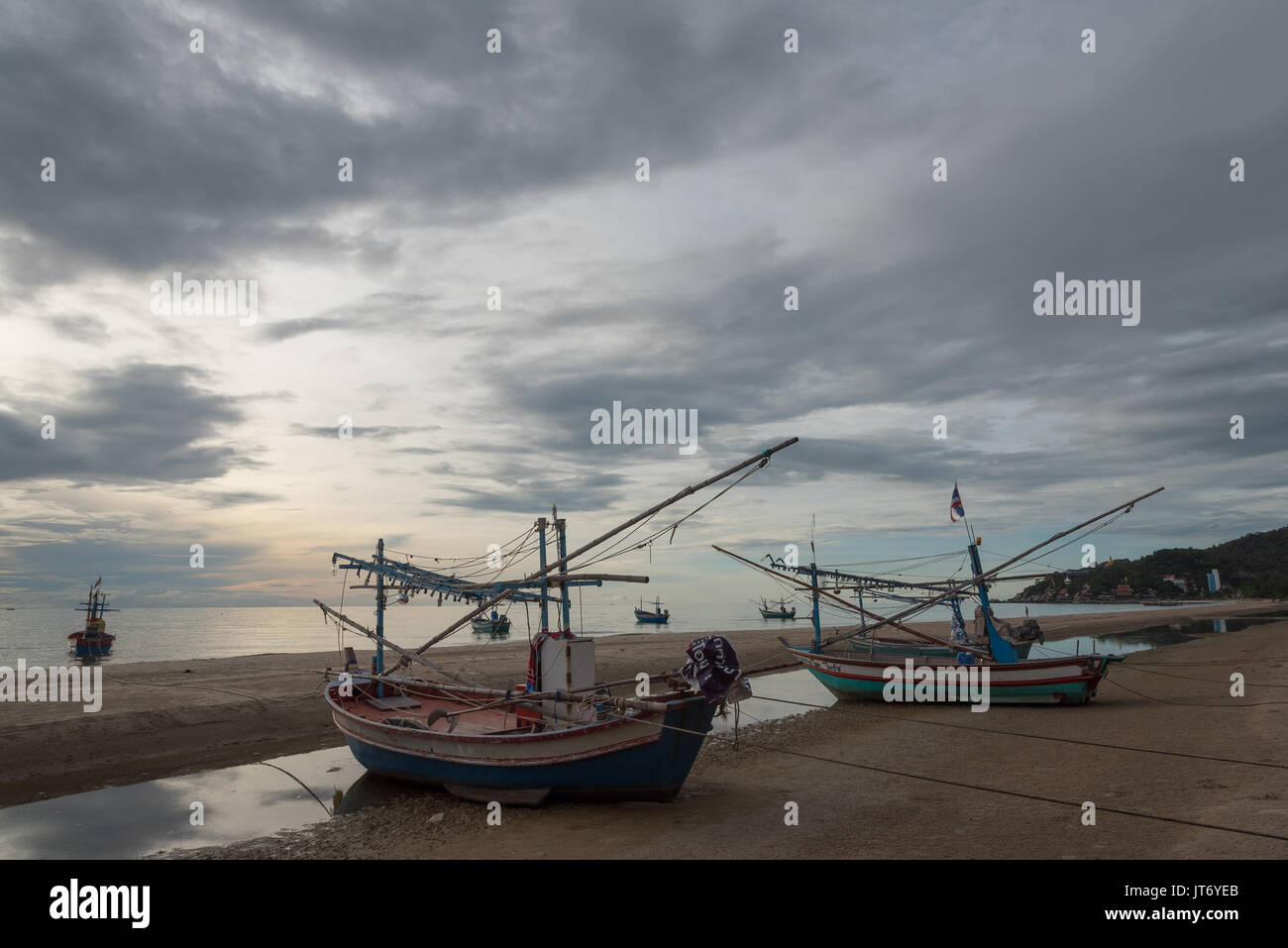 Fishing Boats Moored On The Hua Hin Beach At Low Tide Stock Photo