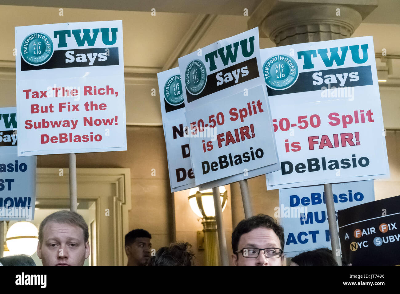 New York, USA. 07th Aug, 2017. Supporters of the Mayor's plan are seen holding signs during the press conference. New York City Mayor Bill de Blasio and city officials held a press conference at Brooklyn Borough Hall to announce plans for funding a new half-price transit Metrocard system for the City's lower-income residents. The Mayor's office is demanding passage of a new City tax on individual incomes over $500,000 USD. The additional 0.534% tax increase on qualifying individuals is expected to generate $1. Credit: PACIFIC PRESS/Alamy Live News Stock Photo