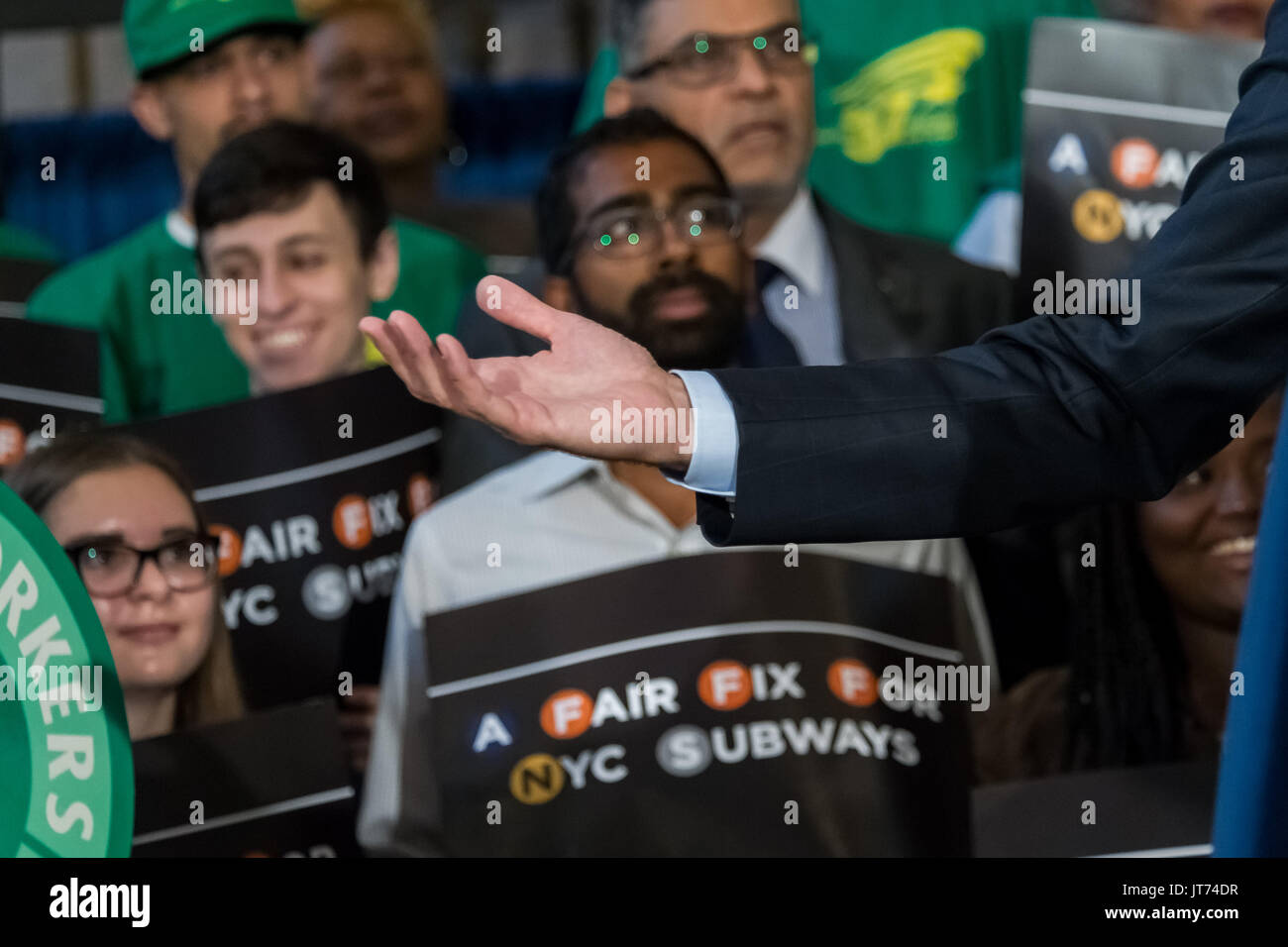 New York, USA. 07th Aug, 2017. Supporters of the Mayor's plan are seen while the Mayor gestures during the press conference. New York City Mayor Bill de Blasio and city officials held a press conference at Brooklyn Borough Hall to announce plans for funding a new half-price transit Metrocard system for the City's lower-income residents. The Mayor's office is demanding passage of a new City tax on individual incomes over $500,000 USD. The additional 0.534% tax increase on qualifying individuals is expected to generate $1. Credit: PACIFIC PRESS/Alamy Live News Stock Photo