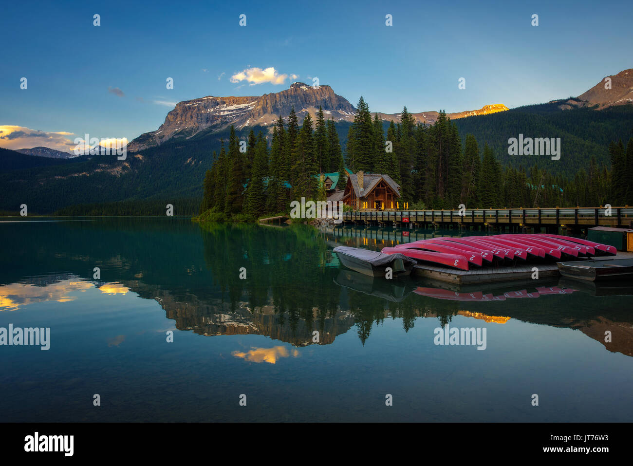 Canoes on beautiful Emerald Lake with lake lodge and restaurant in the background at sunset, Yoho National Park, Canada. Stock Photo