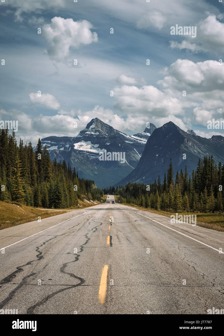 Scenic view of the road and canadian rockies on Icefields Parkway. It travels through Banff and Jasper National Parks and offers spectacular views of  Stock Photo