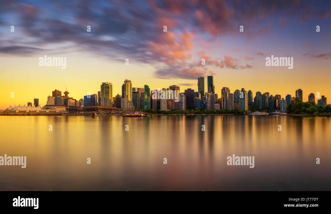 Sunset skyline of Vancouver downtown as seen from Stanley Park, British Columbia, Canada . Long exposure. Stock Photo