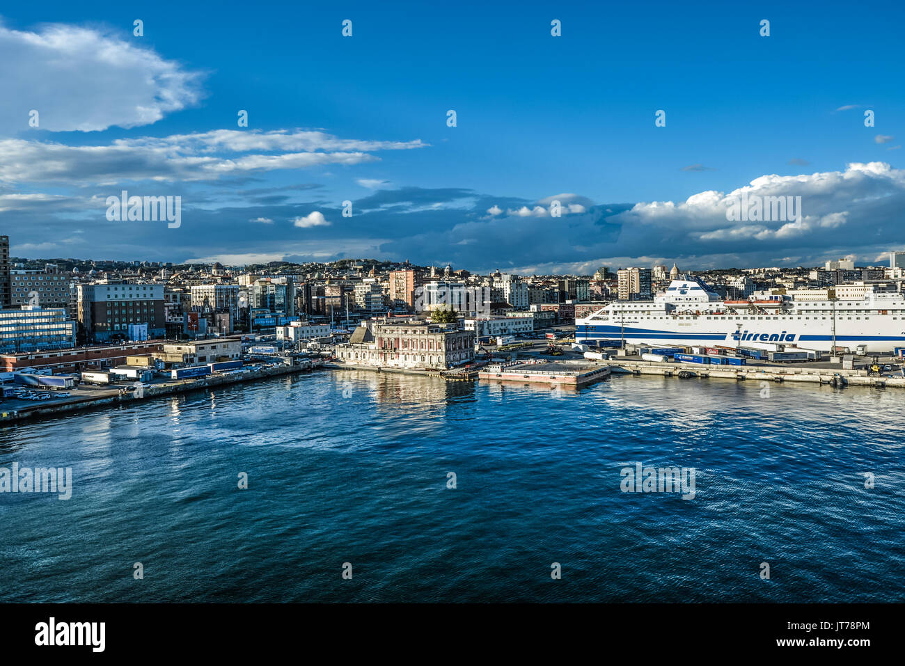 The cruise port with a ship in the bay of Naples in Naples Italy in the late afternoon sun Stock Photo