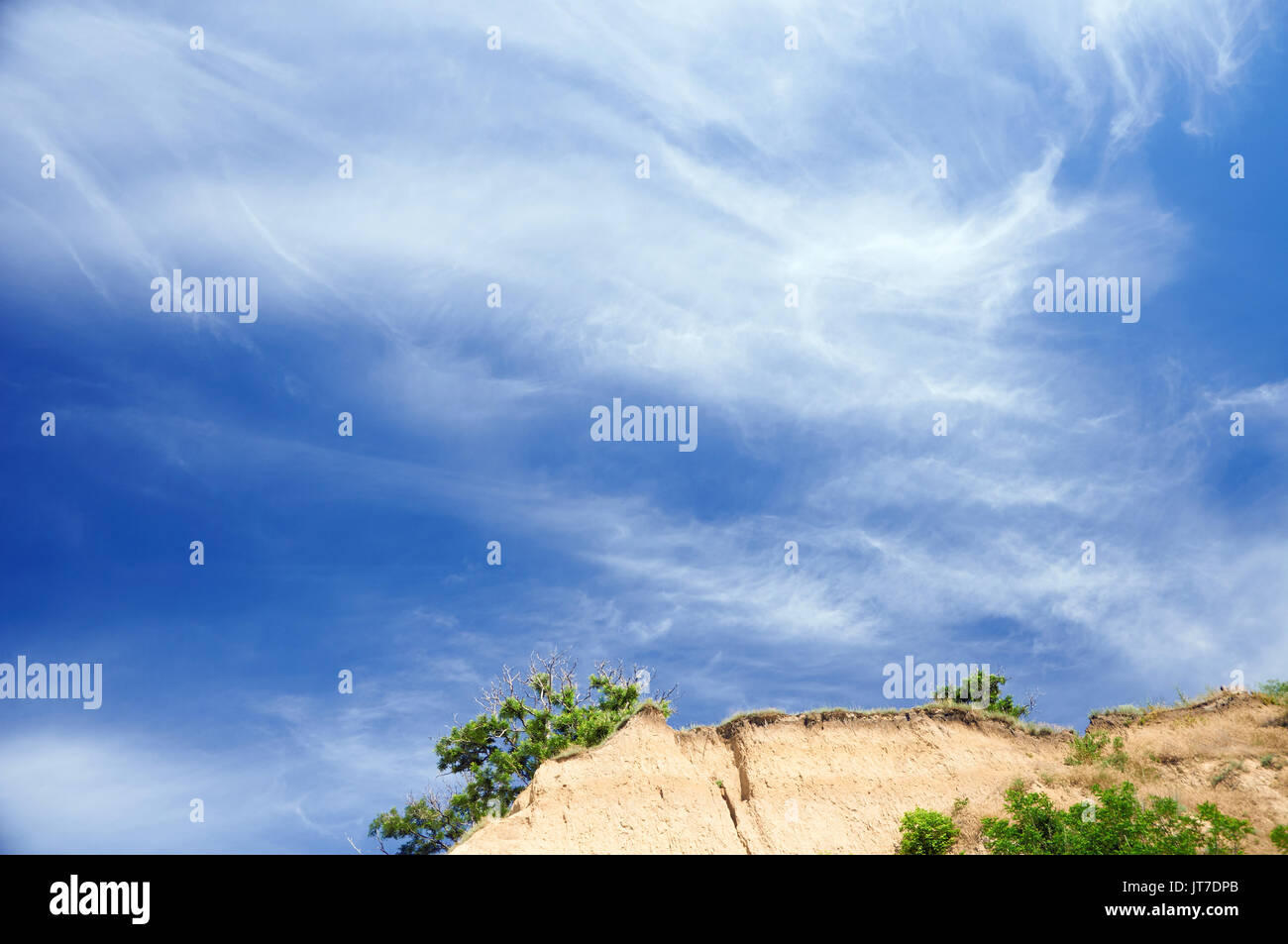 Clear blue sky over cliff peak with a tree Stock Photo