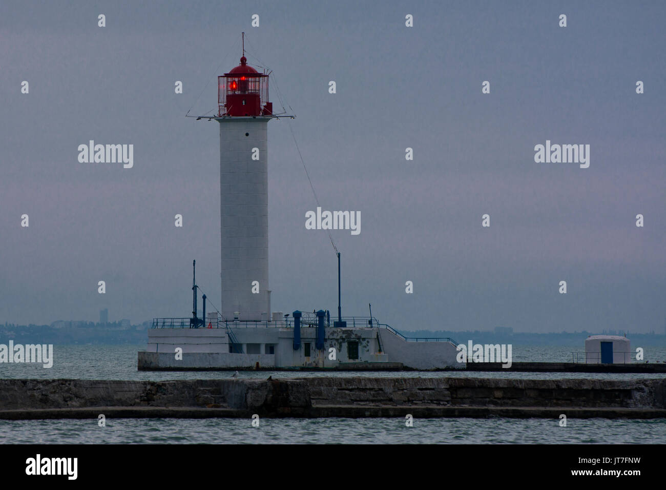 July Lighthouse Lighthouse at the entrance to the seaport of Odessa in the evening of ...