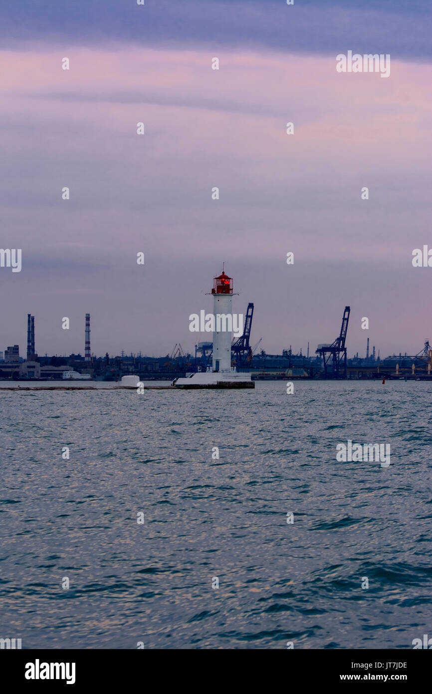 July Lighthouse Lighthouse at the entrance to the seaport of Odessa in the evening of ...