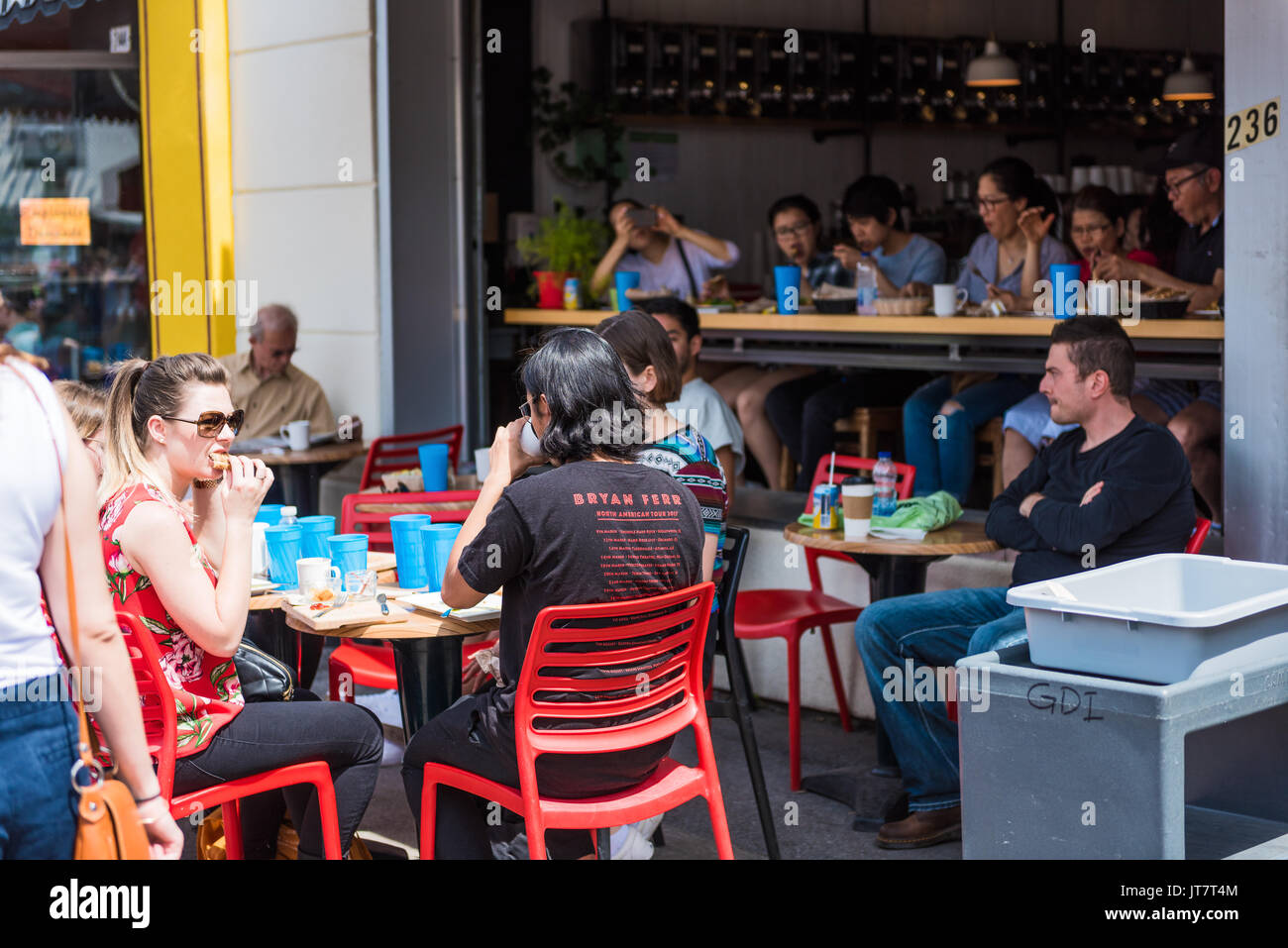 Montreal, Canada - May 28, 2017: Restaurant outside seating area with people sitting at tables at Jean-Talon farmers market Stock Photo