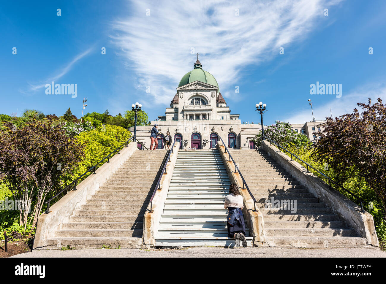 Montreal, Canada - May 28, 2017: St Joseph's Oratory on Mont Royal with woman praying on steps in Quebec region city Stock Photo