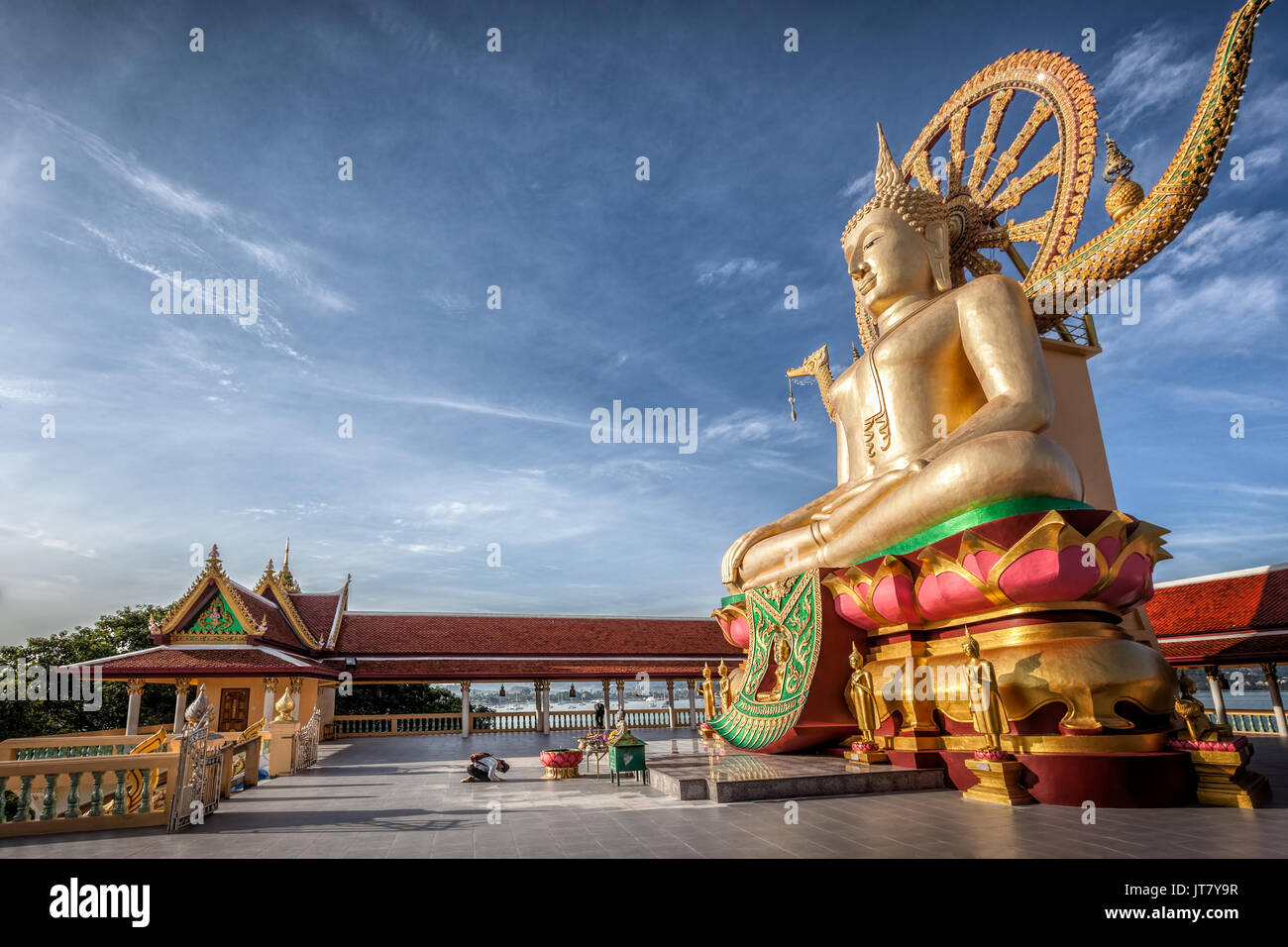 Thai buddhist girl praying in front of Big Buddha, Wat Phra Yai, Kho Samui island, Thailand Stock Photo