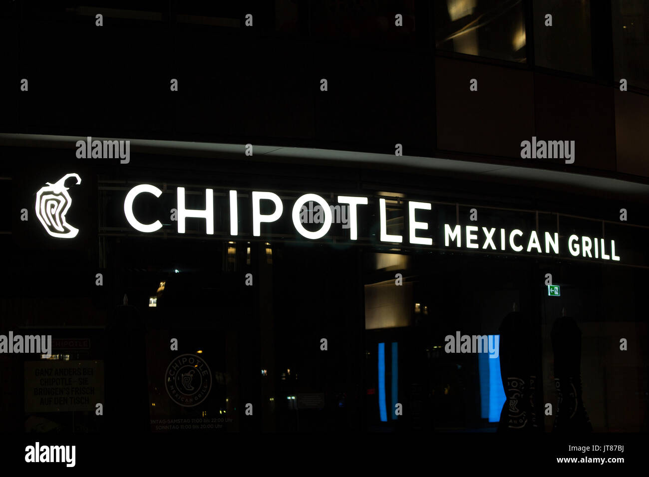 Night view of signage of a famous, international Mexican fast food brand's store in Frankfurt. Stock Photo