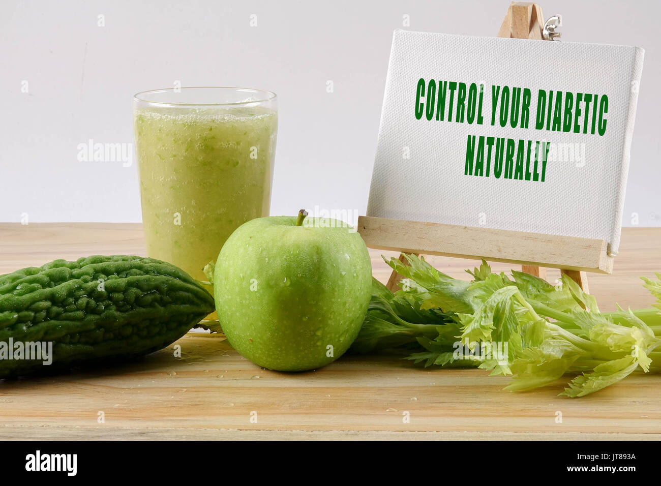 Green apple, bitter gout and celery isolated on wooden background to