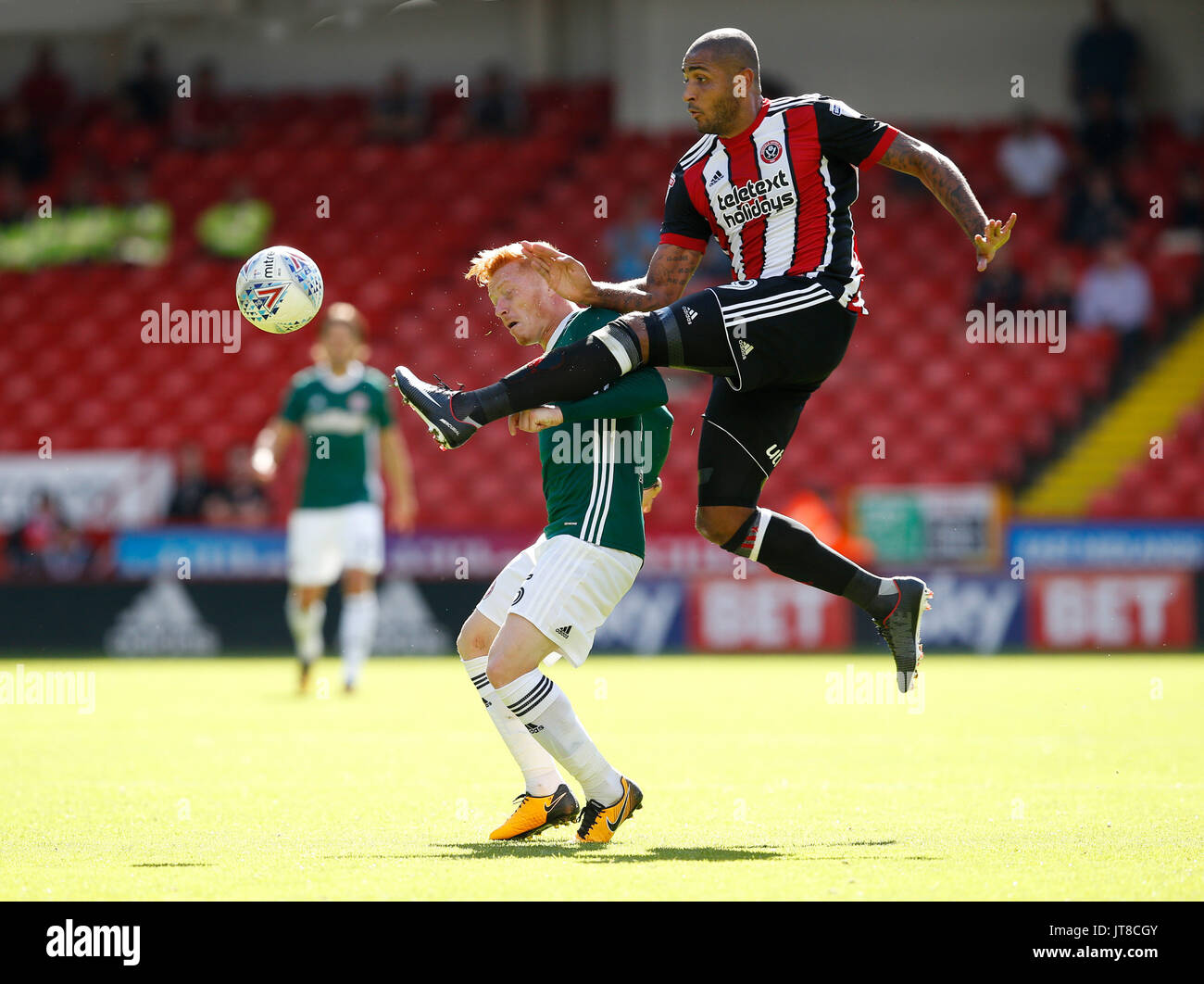 August 5, 2017 - Sheffield, United Kingdom - Leon Clarke of Sheffield Utd leaps above Ryan Woods of Brentford during the English Championship League match at Bramall Lane Stadium, Sheffield. Picture date: August 5th 2017. Pic credit should read: Simon Bellis/Sportimage/CSM Stock Photo