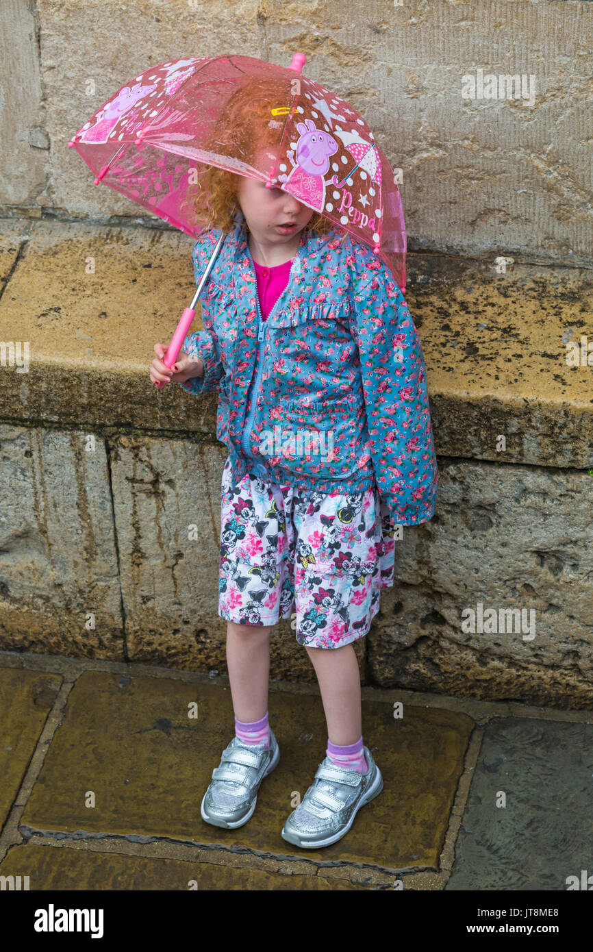 Oxford, Oxfordshire, UK. 8th Aug, 2017. UK weather: wet day with heavy rain at Oxford doesn't deter tourists. Young girl shelters under Peppa Pig umbrella. Credit: Carolyn Jenkins/Alamy Live News Stock Photo