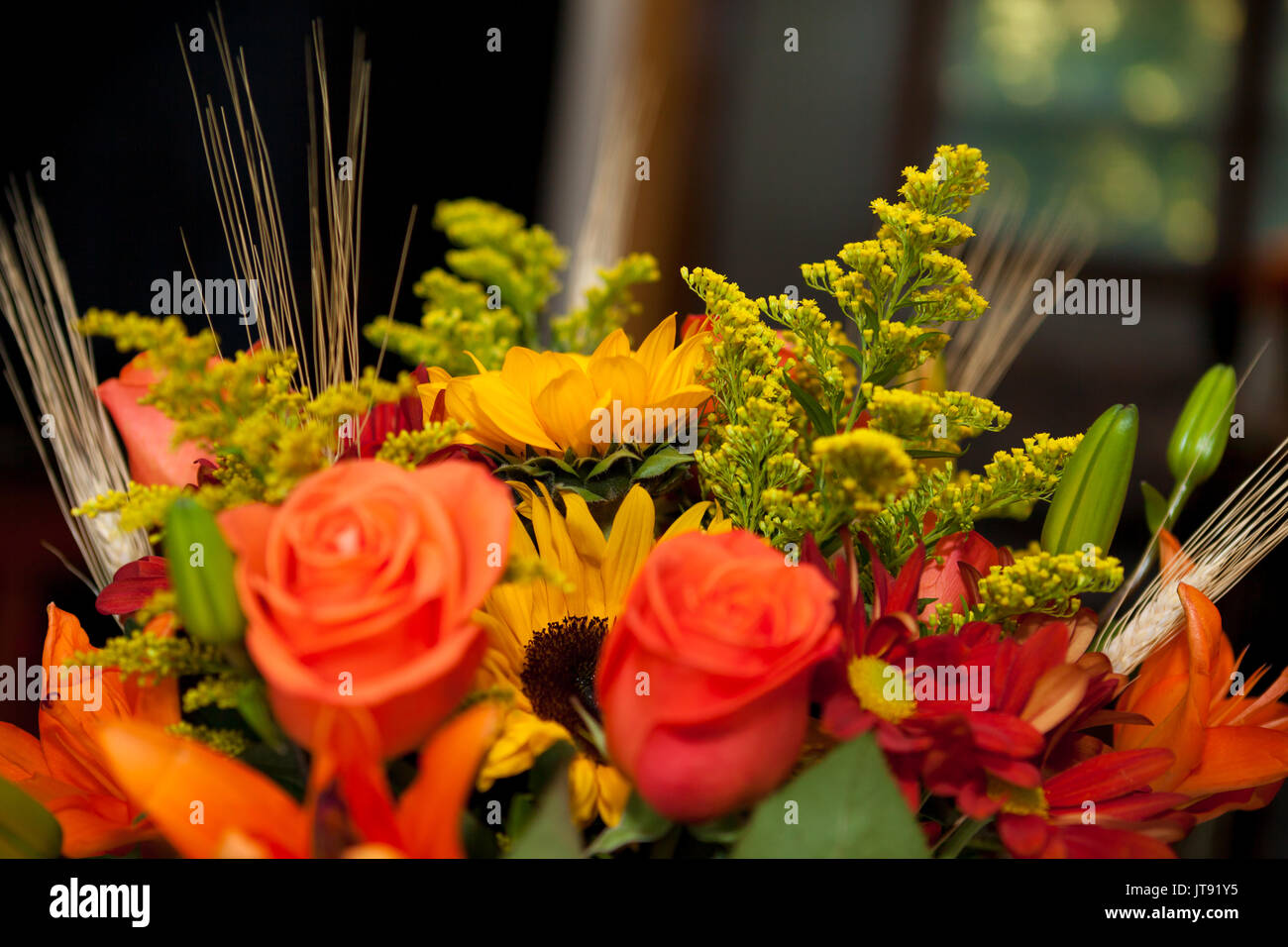 Bouquet of various fresh colorful flowers, green blurred background Stock Photo