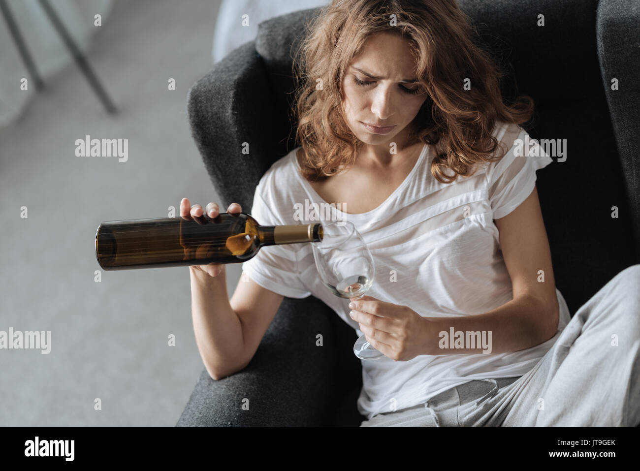 Upset moody woman having problems with alcohol Stock Photo