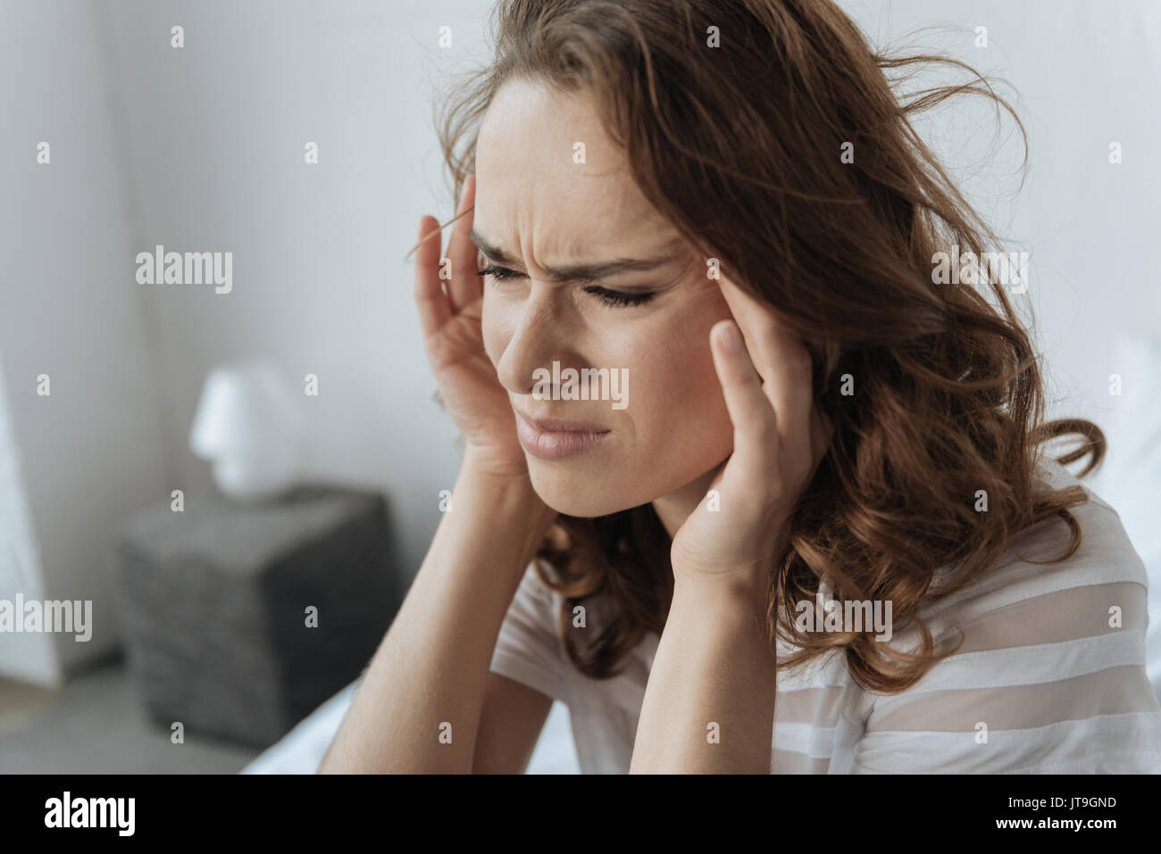 Young woman holding temples hi-res stock photography and images - Alamy