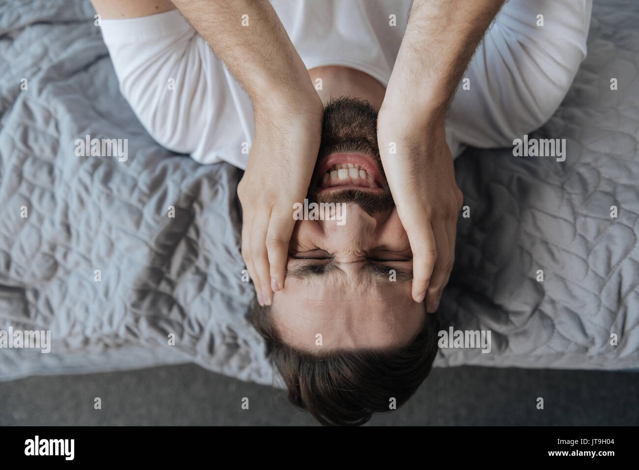 Portrait of a man holding his face Stock Photo - Alamy