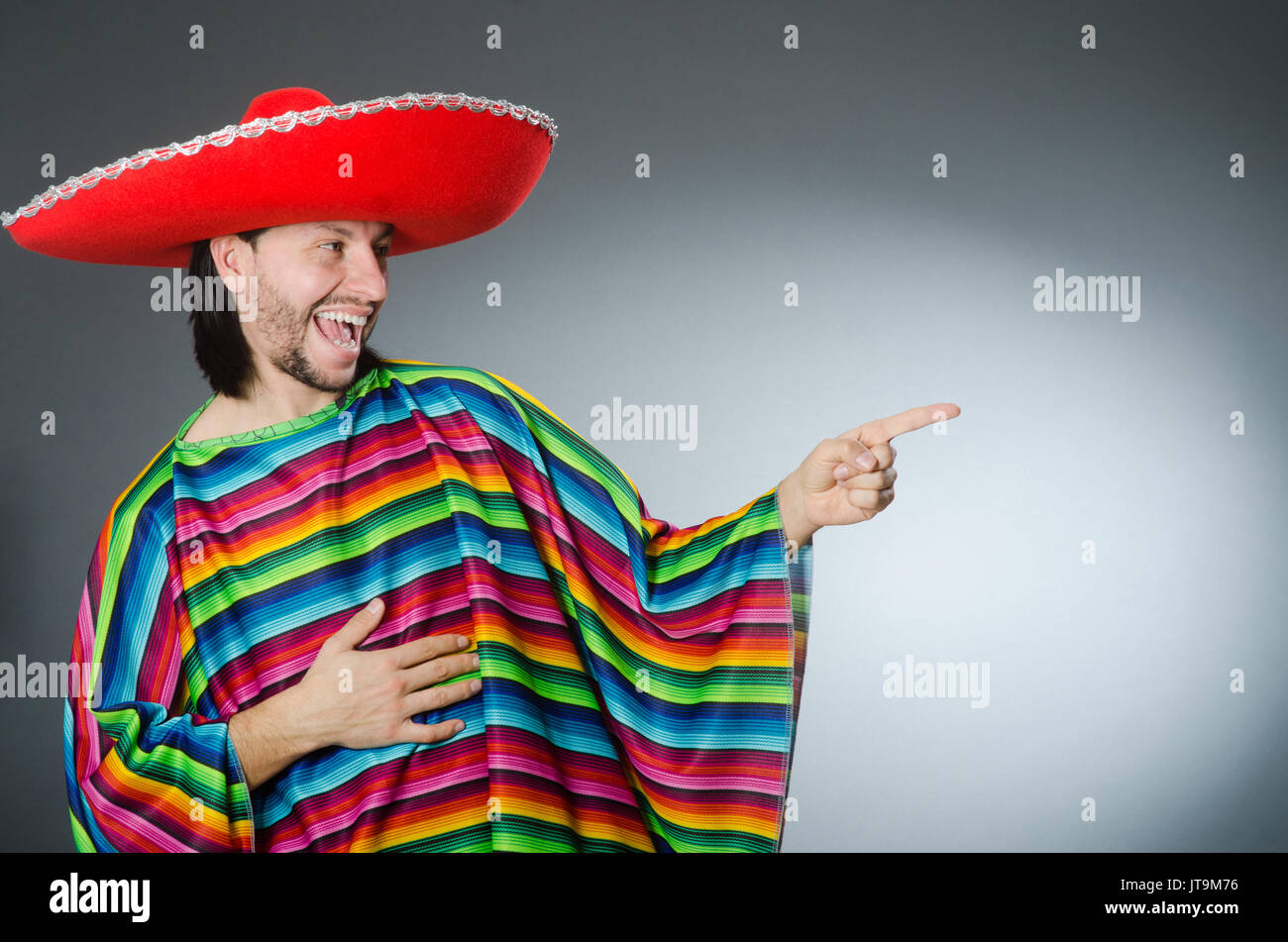 Man in a vivid mexican poncho gray background isolated Stock Photo - Alamy