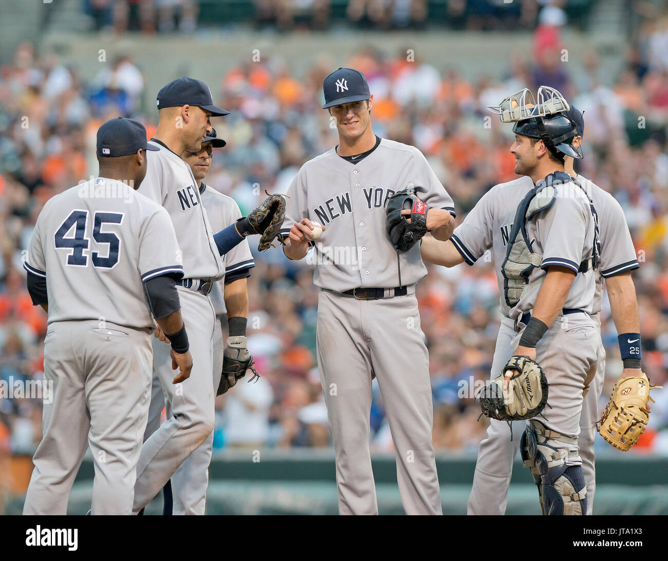 New York Yankees pitcher  Shane Greene (61), center, is congratulated by his teammates after he faced his last batter in the eighth inning against the Baltimore Orioles at Oriole Park at Camden Yards in Baltimore, MD on July 12, 2014. Greene retired Oriole pinch-hitter Steve Clevenger to secure the first out in the eighth before he was replaced.  The Yankees won the game 3 - 0.  From left to right: third baseman Zelous Wheeler (45), shortstop Derek Jeter (2), second baseman Brian Roberts (14), Greene, catcher Francisco Cervelli (29), and first baseman Mark Teixeira (25). Credit: Ron Sachs / CN Stock Photo
