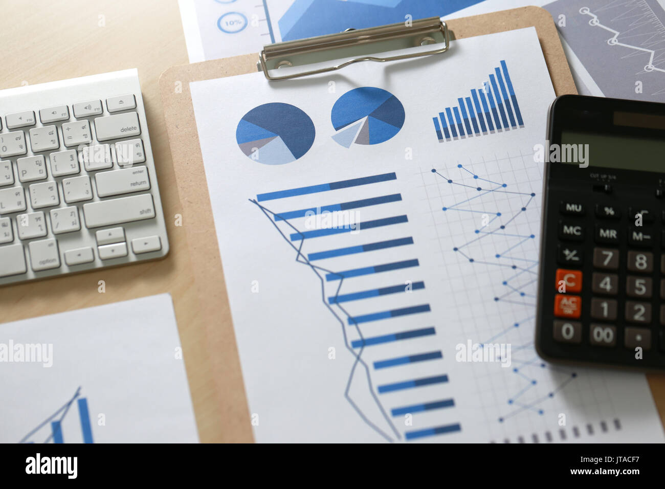 Business reports  Teamwork on table report  of documents Blue graphs and charts financial paperwork and reports Stock Photo