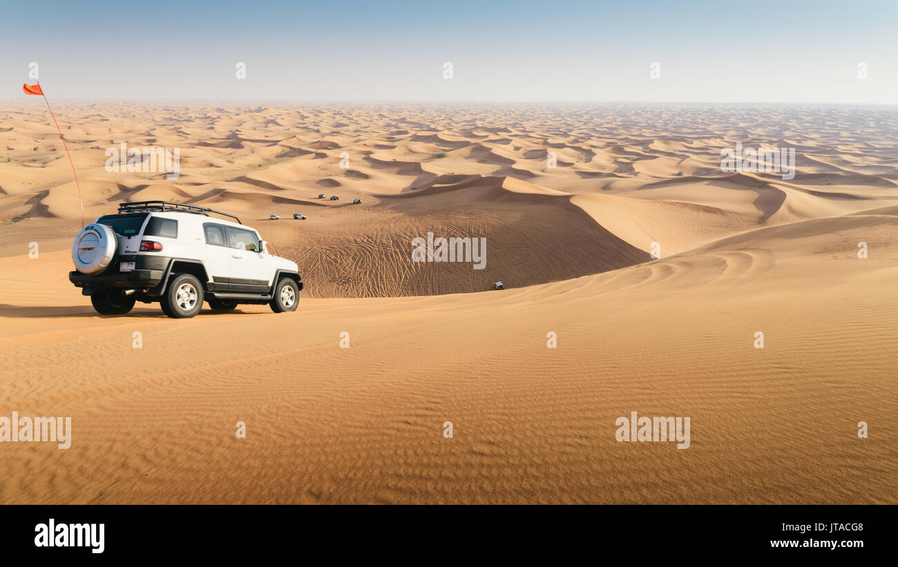 Off road vehicle on sand dunes near Dubai in the United Arab Emirates, Middle East Stock Photo