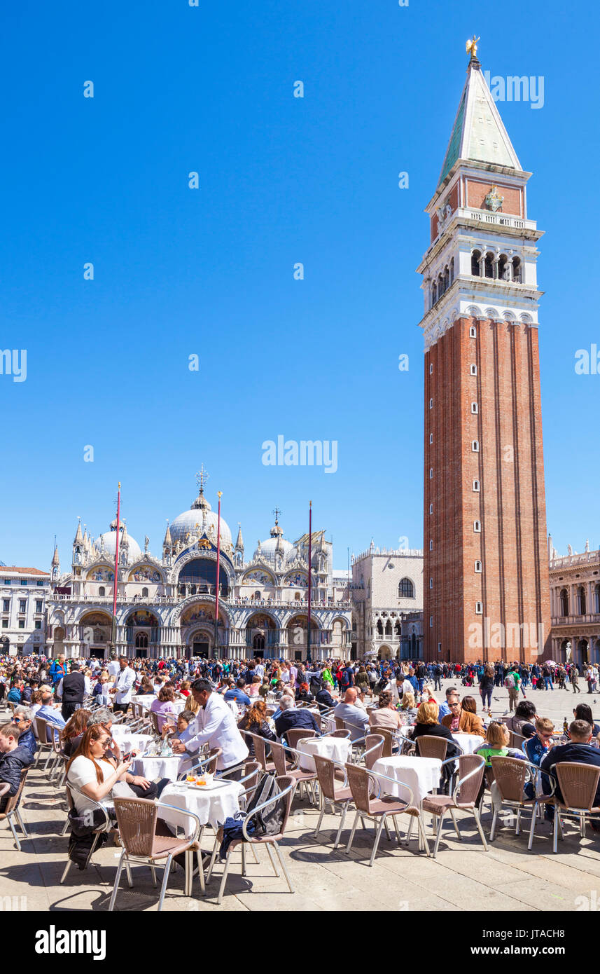 Campanile, Basilica di San Marco, Piazza San Marco, tourists and the cafes of St. Marks Square, Venice, UNESCO, Veneto, Italy Stock Photo