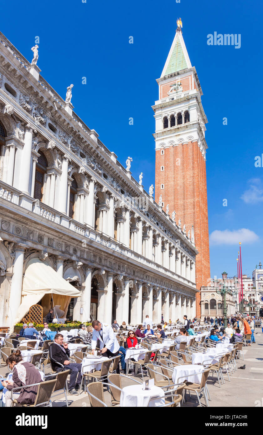Campanile tower, Piazzetta, and tourists enjoying the cafes of St. Marks Square, Venice, UNESCO, Veneto, Italy, Europe Stock Photo