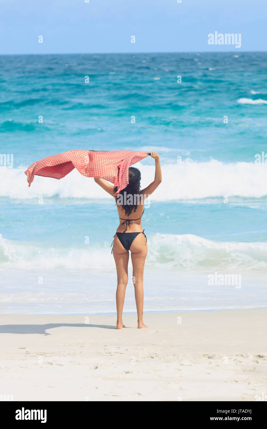 Young Brazilian woman, 20 to 29 years old, with a beach shawl blowing in the wind, Rio de Janeiro, Brazil Stock Photo