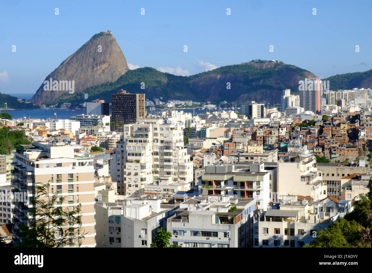 View of a favela with the Sugar Loaf in the background, Rio de Janeiro, Brazil Stock Photo
